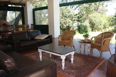 a living room with a couch and chairs and a table at The Red Barn in Weimershoek