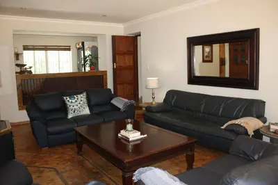 a living room with couches and a coffee table at The Red Barn in Weimershoek