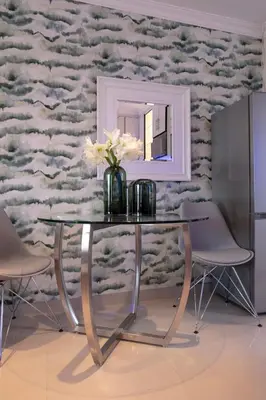 a dining room table with a mirror and flowers on it at The Wilcrest Apartment in Randjesfontein