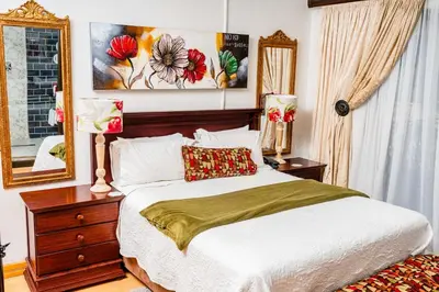 a bedroom with a large bed and a mirror at Re-Union Vacations in Hartbeespoort