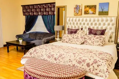 a bedroom with a large bed and a couch at Re-Union Vacations in Hartbeespoort