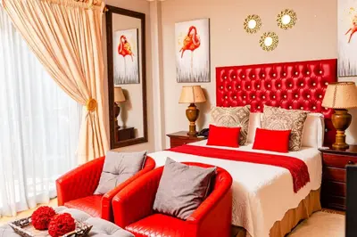 a bedroom with a red bed and two red chairs at Re-Union Vacations in Hartbeespoort