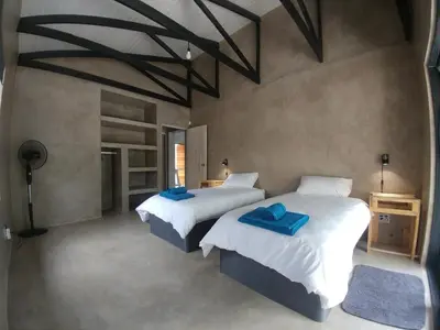 a bedroom with two beds with blue towels on them at Lionsview Private Lodge - 6 Lions in Marloth Park