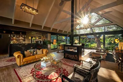 a living room with a couch and a table at Kings Camp in Timbavati Game Reserve