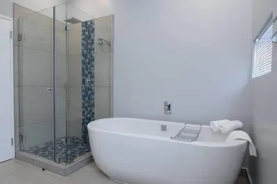 a white bath tub in a bathroom with a shower at Elridge Living in Boksburg
