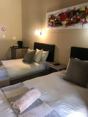 two beds in a hotel room with two beds sidx sidx sidx at Jock of the Bushveld in Barberton