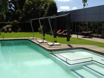 a swimming pool with a swing in a building at Southern Sun OR Tambo International Airport in Kempton Park