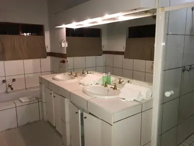 a bathroom with two sinks and a large mirror at Greenwoods Self-Catering in Pretoria