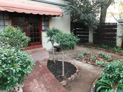 a garden in front of a house at Greenwoods Self-Catering in Pretoria