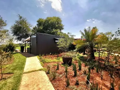 a garden with a black house at Arendskop in Pretoria