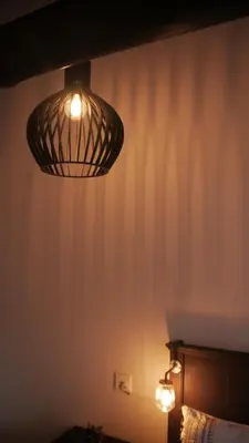 a light hanging from the ceiling of a bedroom at Arendskop in Pretoria