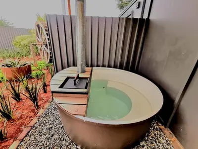 a bath tub sitting next to a fence at Arendskop in Pretoria