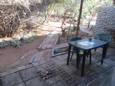 a table and two chairs on a patio at At Rest Bushstay in Hoedspruit