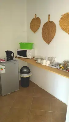 a kitchen with a counter with a microwave and a refrigerator at At Rest Bushstay in Hoedspruit