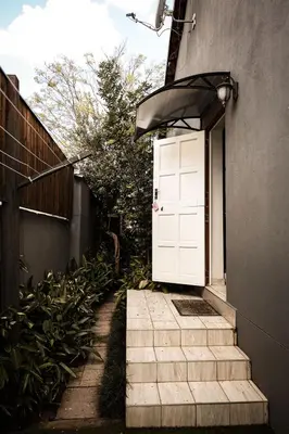 a white door on the side of a building at Maryah House in Pretoria