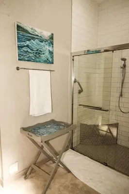 a bathroom with a shower and a glass table at Maryah House in Pretoria