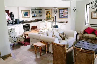 a living room with a couch and a table at Camellia Haven in Pretoria