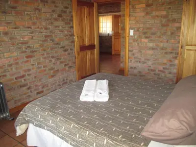 a bedroom with a bed with towels on it at Thaba Tsweni Lodge & Safaris in Graskop