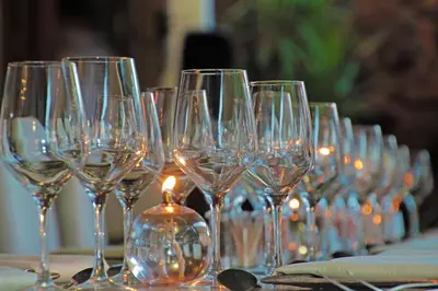 a row of wine glasses sitting on a table at Casa Toscana Lodge in Pretoria