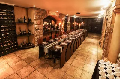 a long table in a room with wine bottles at Casa Toscana Lodge in Pretoria