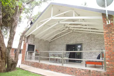 a patio with awning on a brick building at Klippan River Lodge in Groblersbrug