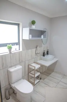 a bathroom with a toilet and a sink at Klippan River Lodge in Groblersbrug