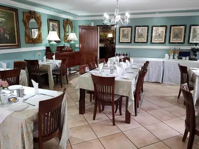a dining room with tables and chairs in a restaurant at Pheasant Hill Bed and Breakfast in Rietvalleirand