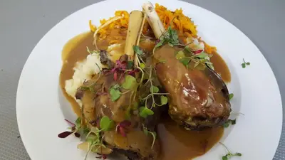 a plate of food with meat and mashed potatoes at Pheasant Hill Bed and Breakfast in Rietvalleirand