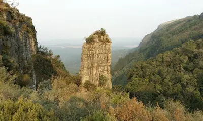 a large stone pillar in the middle of a mountain at Sabie Self Catering Apartments in Sabie