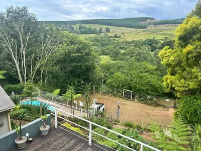 a view from the deck of a house with a pool at Sabie Self Catering Apartments in Sabie