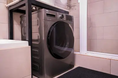 a washing machine in a room with a window at Gaza Homes Self Catering Apartments in Nelspruit