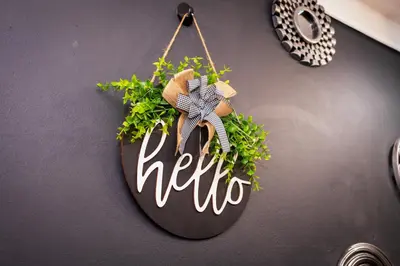 a sign that says hello hanging on a wall at Gaza Homes Self Catering Apartments in Nelspruit