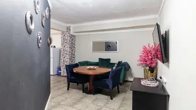 a living room with a table and a couch at Gaza Homes Self Catering Apartments in Nelspruit