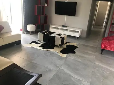 a living room with a rug on the floor at KwaSiya Guest House in Nelspruit