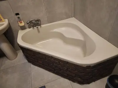 a bath tub in a bathroom with a sink at Le Grix Guesthouse in Nelspruit
