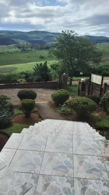 a view of a garden with a stone walkway at Hamba Kancane Ma-Africa Guest House in Graskop