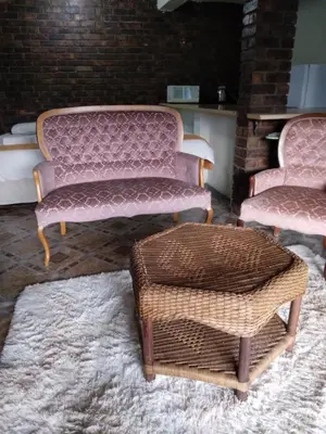 two pink chairs and a wicker stool in a room at Hamba Kancane Ma-Africa Guest House in Graskop