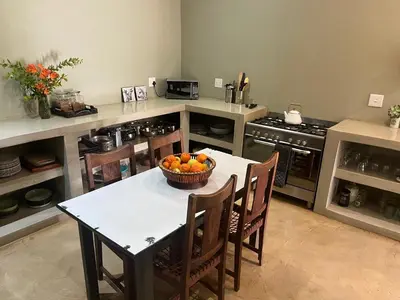 a kitchen with a table with a bowl of oranges on it at Ploughman’s Rest in Ohrigstad