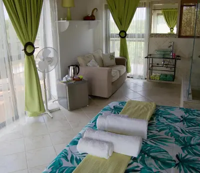 a living room with towels on a table at Baobab - NUDE - SunEden Family Naturist Resort in Pretoria