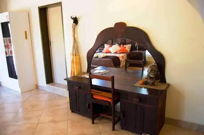 a desk in a room with a bed and a bedroom at Baobab - NUDE - SunEden Family Naturist Resort in Pretoria