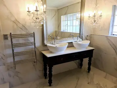 a bathroom with two sinks in front of a mirror at Diamantvallei Landgoed in Rayton
