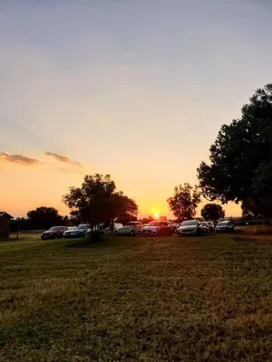 a group of cars parked in a field at sunset at Diamantvallei Landgoed in Rayton