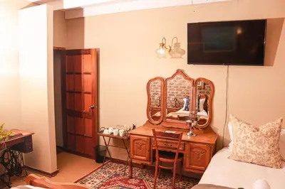 a bedroom with a dressing table and a mirror at Diamantvallei Landgoed in Rayton