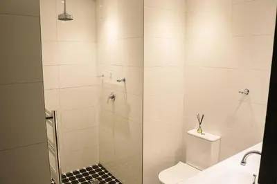 a bathroom with a shower with a toilet and a sink at Diamantvallei Landgoed in Rayton