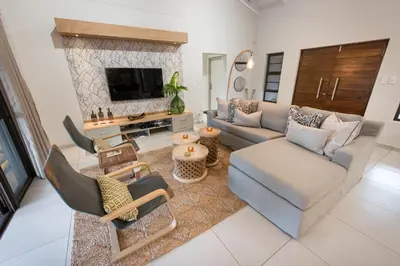 a living room with a couch and a fireplace at Bushwillow Private Villa in Hoedspruit