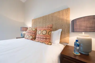 a bedroom with a large white bed with pillows at Bushwillow Private Villa in Hoedspruit