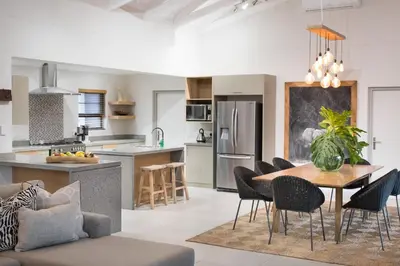 a kitchen and dining room with a table and chairs at Bushwillow Private Villa in Hoedspruit