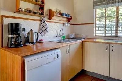 a kitchen with a wooden counter top and a sink at Mrs Simpson in Dullstroom