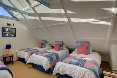 a room with three beds in a attic at Mrs Simpson in Dullstroom