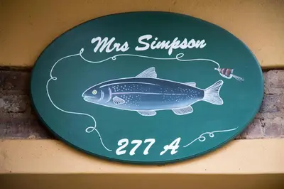 a sign with a fish on it on a wall at Mrs Simpson in Dullstroom
